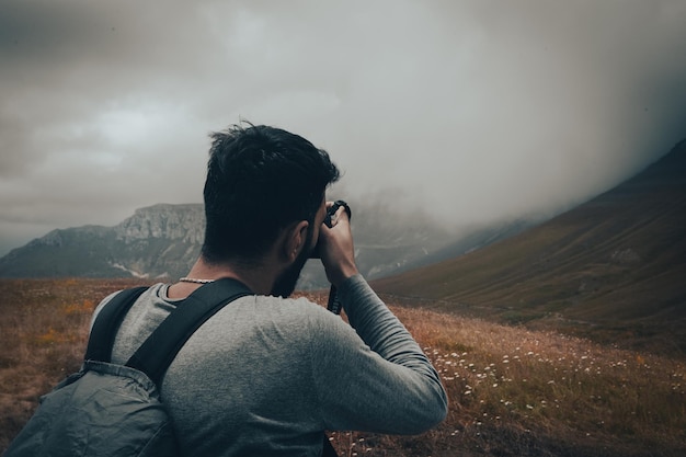 The photographer on the mountain takes a photo