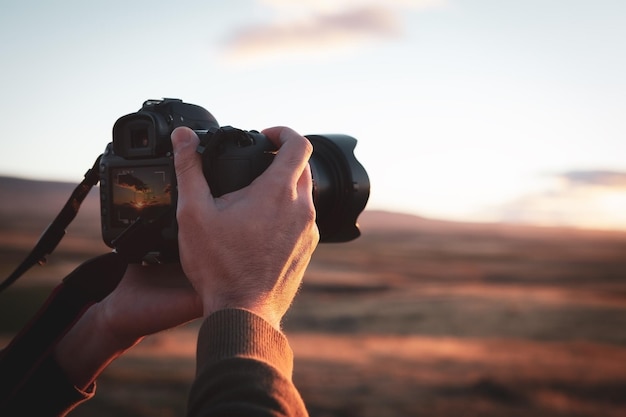 The photographer photographs the sunset in the evening