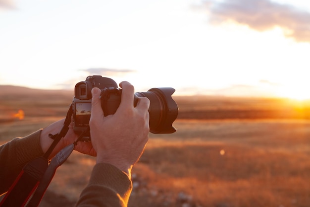 Photographer photographs the sunset on the mountains