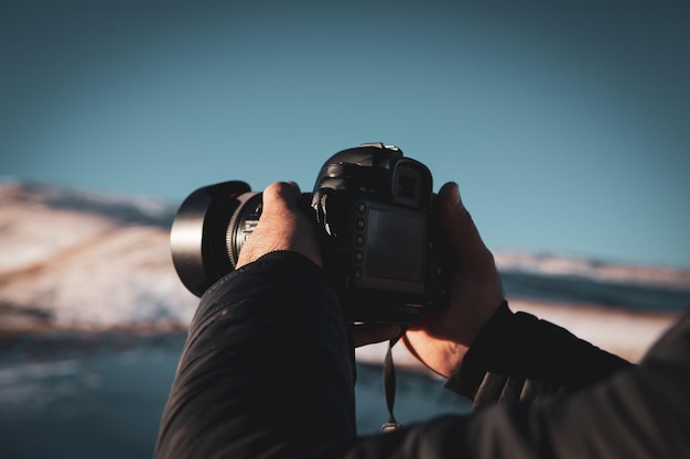 Photographer photographs the sunset on the mountains