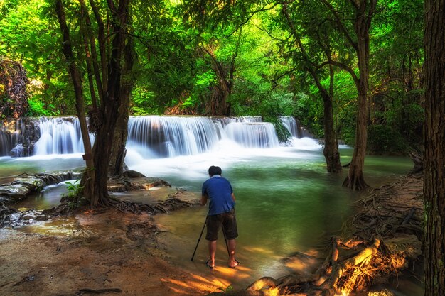 Photographer taking photo scene of Beautiful waterfall