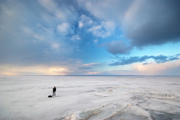 Photographer with a camera on a snowy field