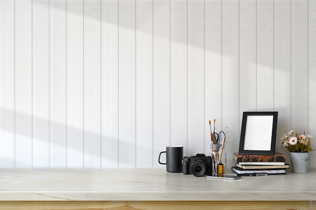 Photographer workspace with supplies and copy space. Marble desk and hipster gadget.