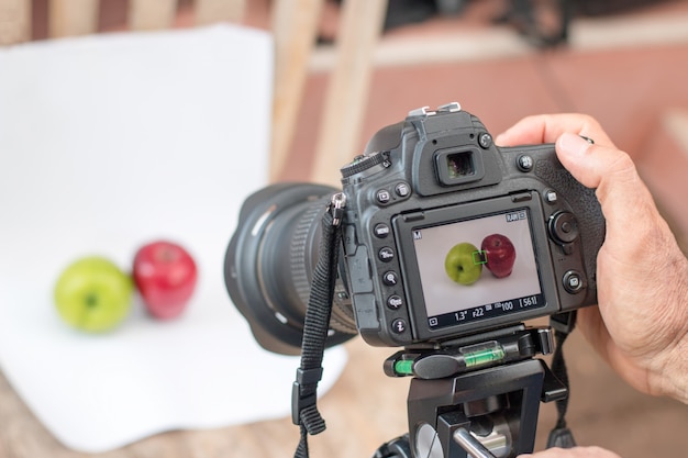 Photographers are using dslr camera shooting fruit on white background select focus camera