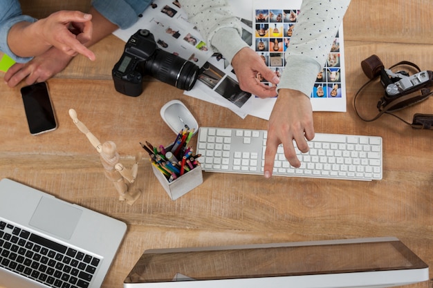 Photographers pointing towards the desktop pc