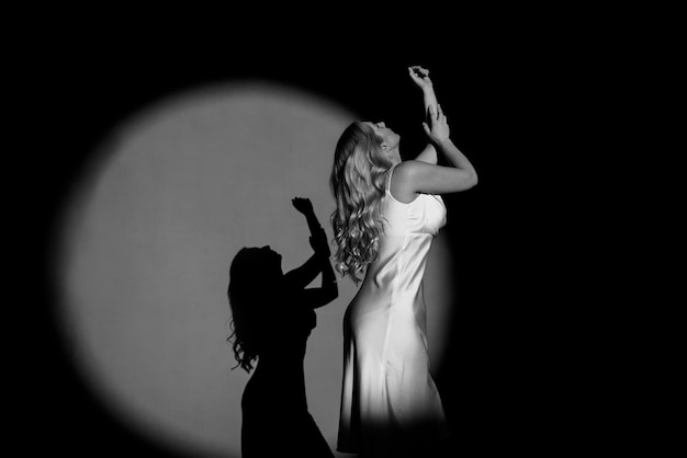 Photographing with Projectors , black and white , light and dark, with the figure of a beautiful girl posing, fashionable toning.