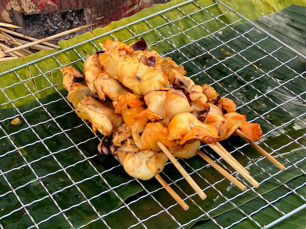 A photography of a grill with a bunch of skewers on it