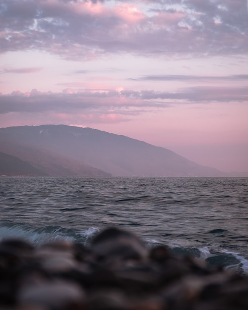 Photography of the sea and mountain silhouettes