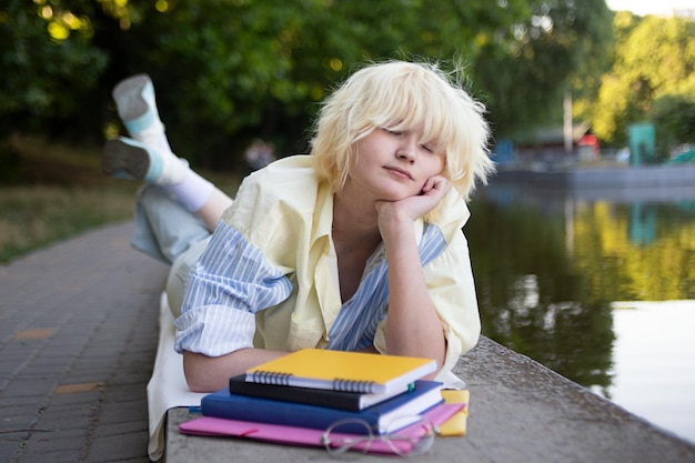 Photography with teenage girlsleeping near the books and students folders