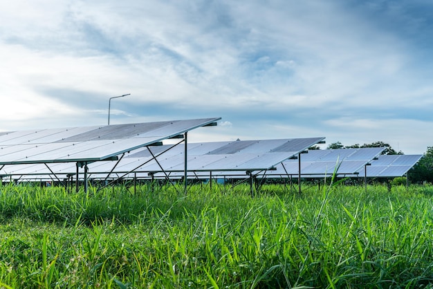 Photovoltaic solar power panel on dramatic sunset blue sky background green clean Alternative power energy concept