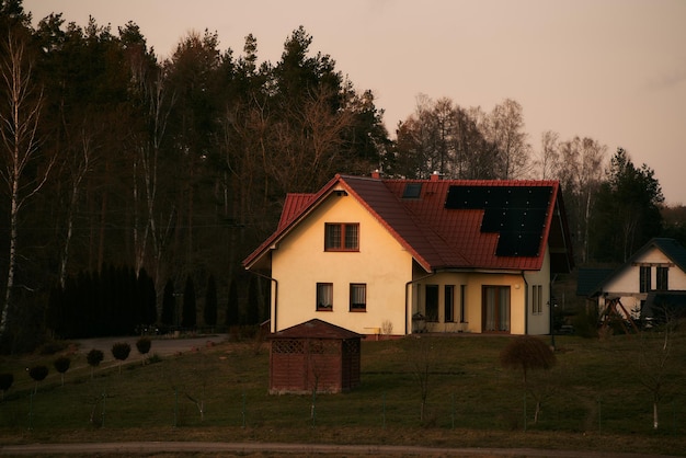 Photovoltaics on the roof of the house Solar energy source and green energy generation in rural areas Ecofriendly cottage house Sustainable future concept