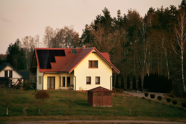 Photovoltaics on the roof of the house Solar energy source and green energy generation in rural areas Ecofriendly cottage house Sustainable future concept