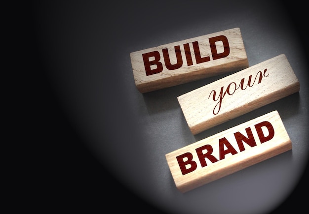 Photo phrase build your brand written on wooden blocks with vintage styled background branding rebranding marketing concept