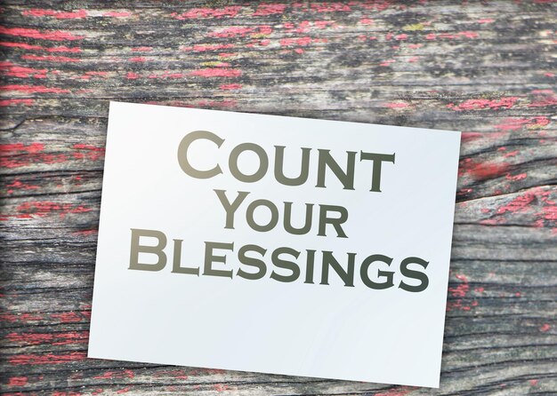 The phrase Count Your Blessings typed on a piece of paper and paper dollar signs around Career concept