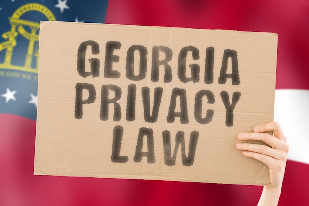 The phrase Georgia privacy law on a banner in mens hand with Georgias flag Private Client