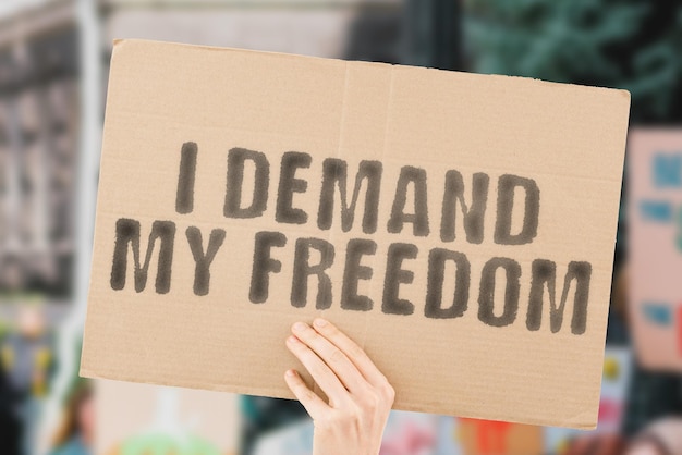 The phrase I demand my freedom on a banner in hand Free Human rights Demanding Protest Strike