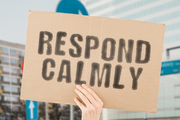 The phrase Respond Calmly on a banner in men's hands with blurred background Mental Furious Crazy Rage Violent Psycho Fool Silly Wrath Frenzy Opposite Hysteria Upset Devil