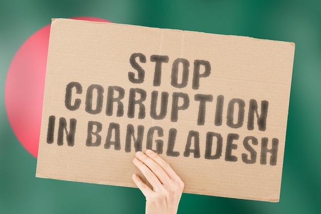 The phrase Stop Corruption in Bangladesh on a banner in men's hand with blurred Bangladeshi flag on the background Forbidden Prevent Wealth Offence Corruptness Economy Corruptible