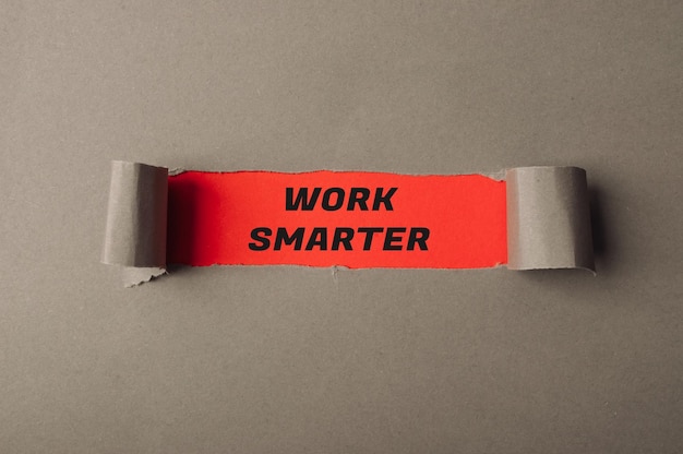 Phrase Work Smarter on red background in torn grey paper