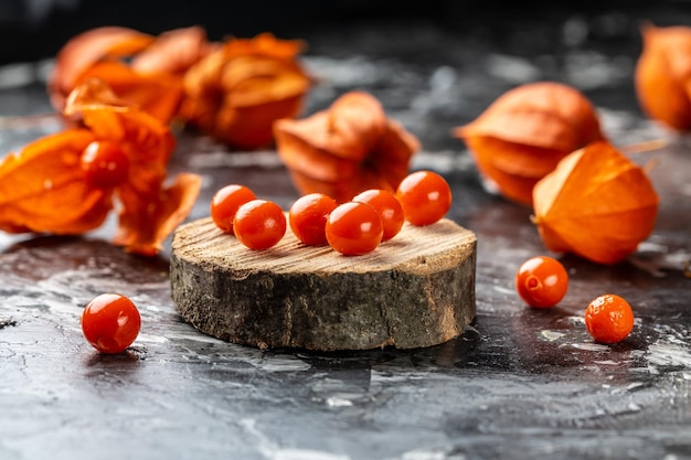 Physalis on wooden stump Ripe berries of autumn red physalis fruit berries fruit Physalis or Chinese Lantern Plants