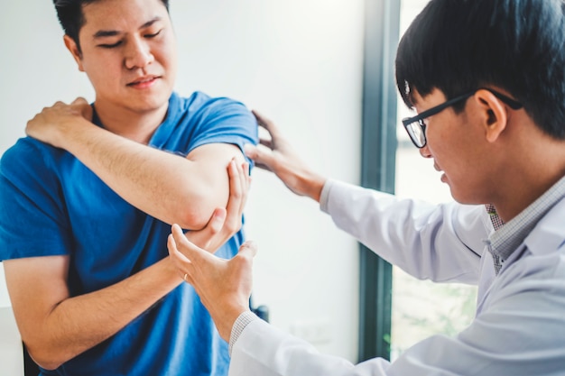 Physical Doctor consulting with patient About elbow muscule pain problems Physical therapy