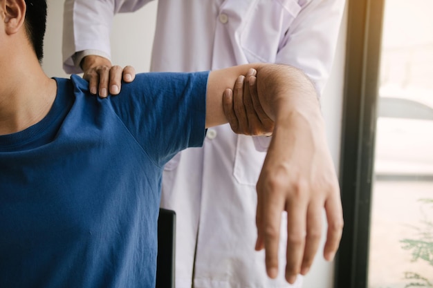 Physical therapists press to the patient shoulder check for pain