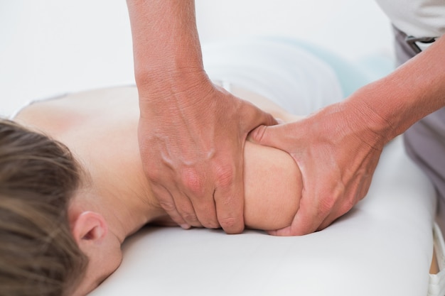 Physiotherapist doing arm massage to his patient