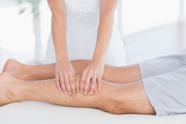 Physiotherapist doing calf massage to her patient