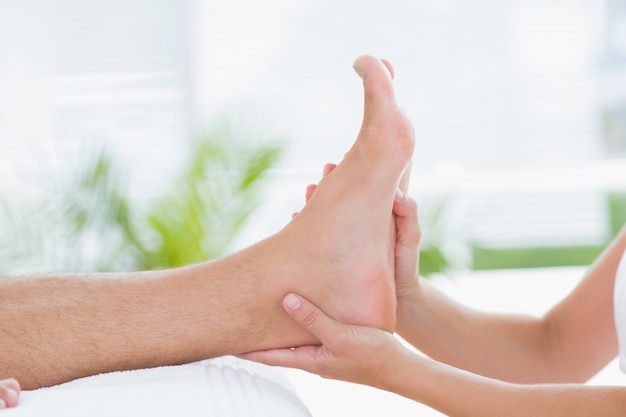 Physiotherapist doing foot massage 