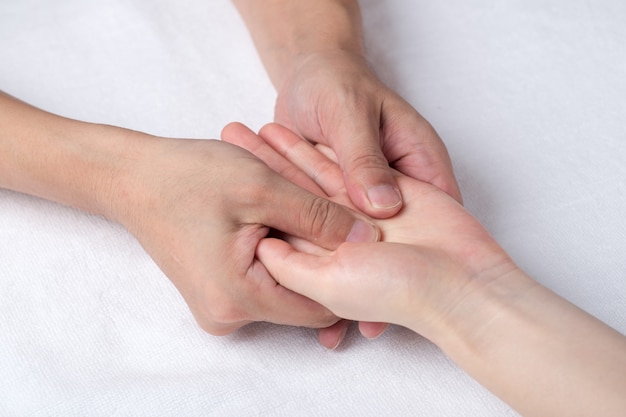 Physiotherapist doing hand massage in medical office