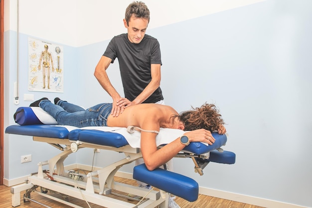 Physiotherapist and his female client during a back treatment