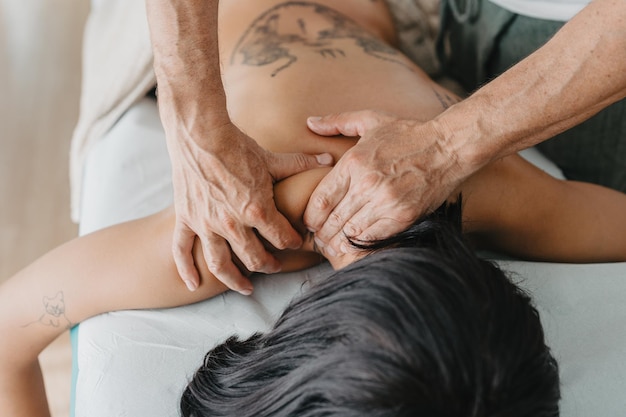 Physiotherapist massaging a woman39s lower neck