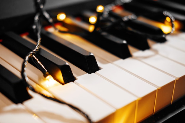 Piano keys bokeh with Christmas lights on the board of piano new year