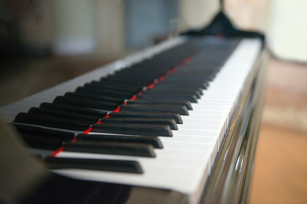 Piano side view with keys lost in the lightside view with shallow depth of field