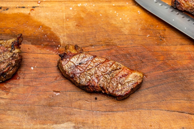 picanha beef steak over wooden cutting board with text are or copy space