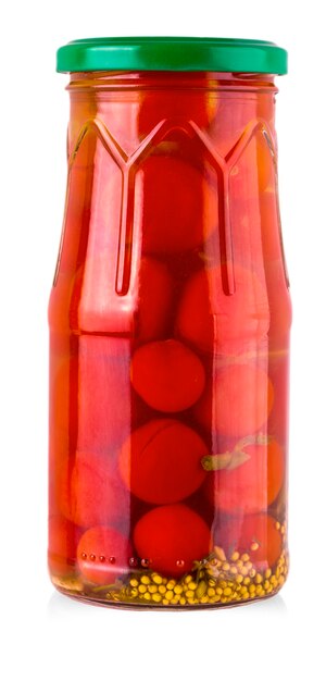 Pickled cherry tomato in glass jar on white background.