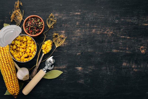 Pickled corn in a jar Stocks of food Top view On a wooden background Copy space