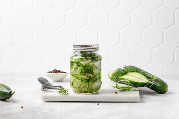 Pickled cucumbers Slices of Marinated cucumbers in glass jars Homemade fermented cucumbers