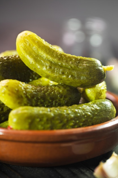 Pickled gherkins. Salted Cucumbers on a dark rustic background, selective focus