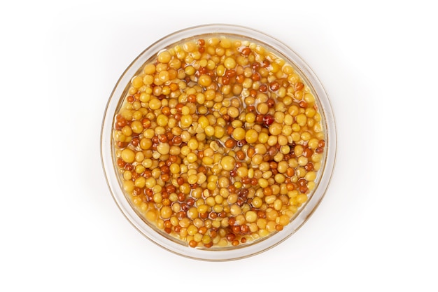 Pickled mustard seeds isolated on a white background.