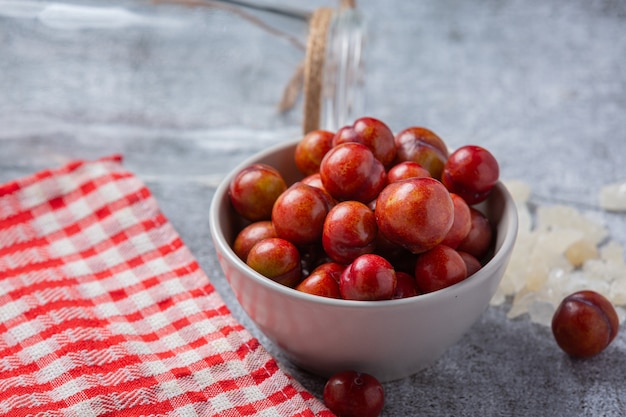 Pickled Plums on the dark surface.