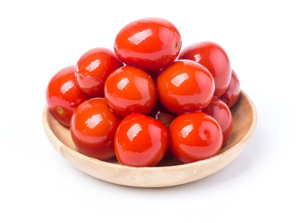 Pickled red tomatoes in bowl isolated on white