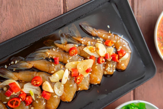 Pickled shrimp in soy sauce or soy sauce and spicy dipping sauce Thai style food.