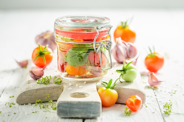 Pickled tomatoes with homegrown vegetables from greenhouse