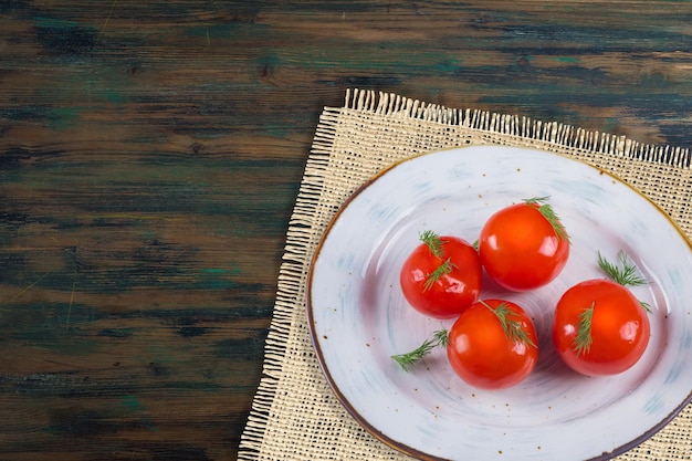 Pickles in a plate on a wooden background