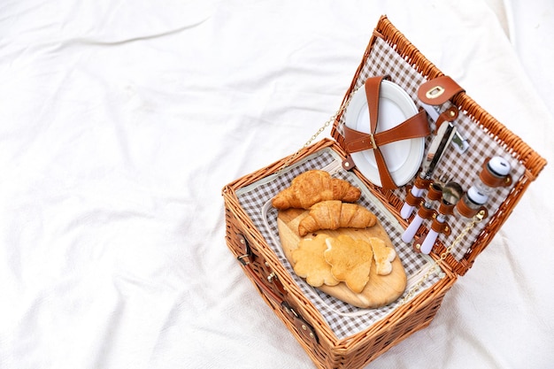 A picnic basket on a lawn at the backyard