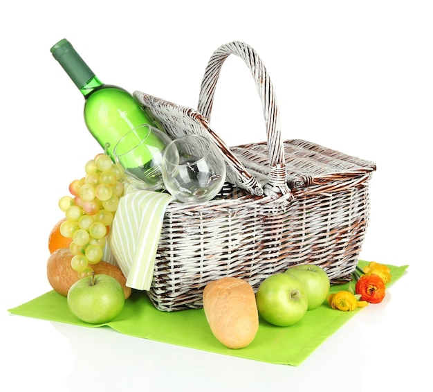 Picnic basket with fruits and bottle of wine isolated on white