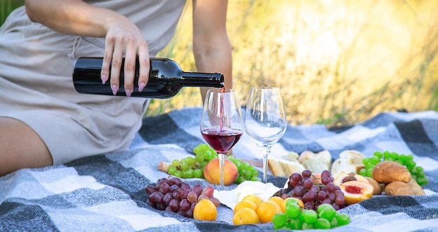 Picnic in nature girl pouring wine couple in love nature