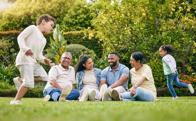 Picnic playing children and happy family relax have fun or enjoy outdoor quality time together nature and wellness Summer freedom grass and bonding grandparents parents and kids running in park