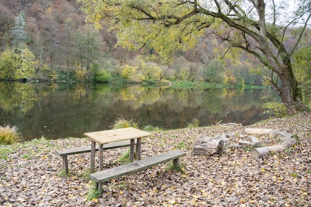 Picnic wooden benches and table by the river berunka in autumn season to relax